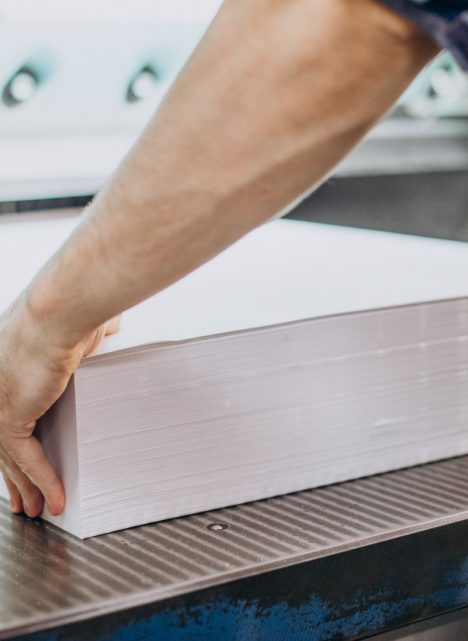 Man working in printing house with paper and paints